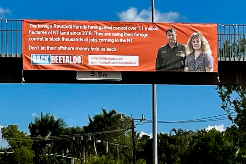 a banner on a pedestrian overpass on Bagot Road. 