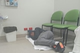 Man lies on the floor at Royal Hobart Hospital, September 2018.