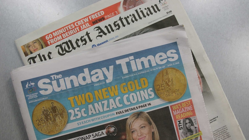 Copies of The Sunday Times and The West Australian lie on a grey table.