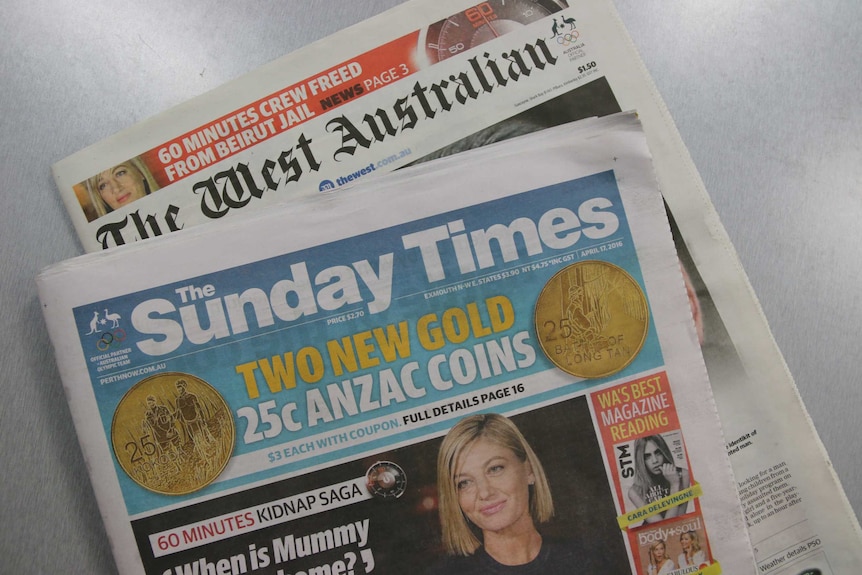 Copies of The Sunday Times and The West Australian lie on a grey table.