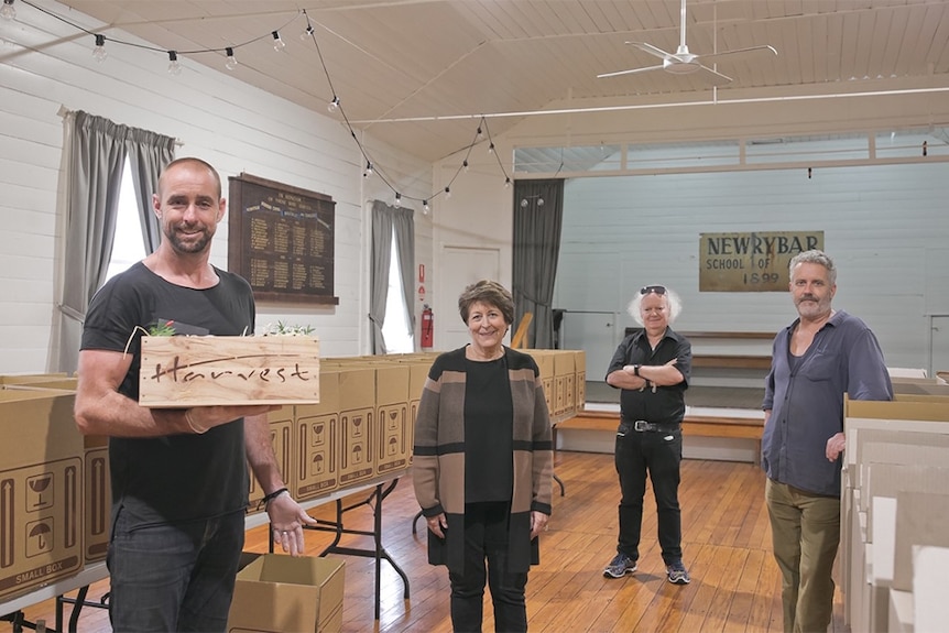 Tristan Grier, Blair Beattie, Sharon Cadwallader and David Wright in Newrybar Hall with food boxes lined up on table.