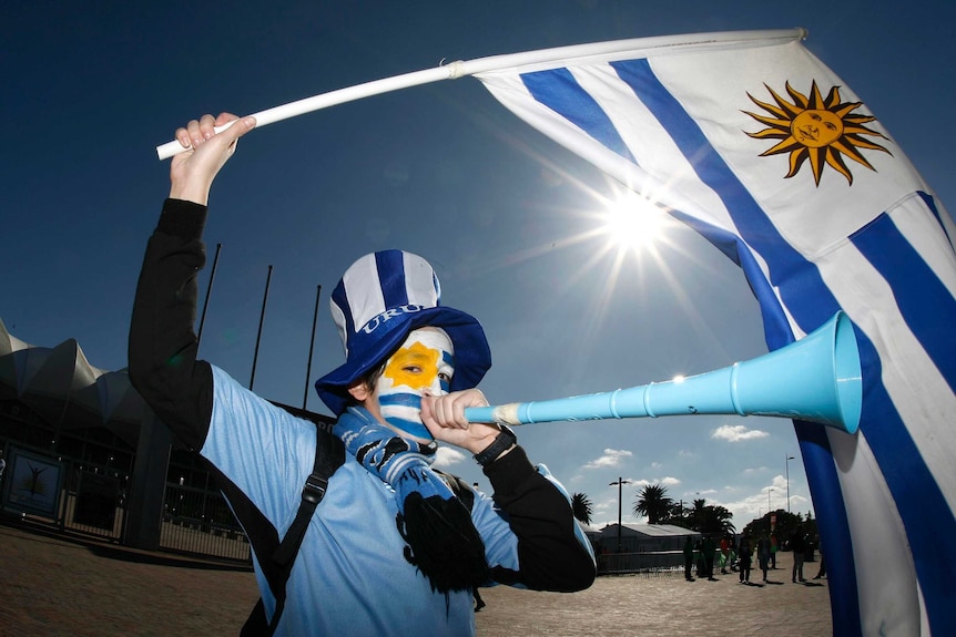 A Uruguay fan blows a vuvuzela before Uruguay v South Korea in Port Elizabeth at World Cup 2010.