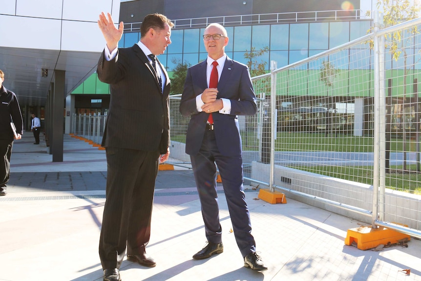 Health Minister Jack Snelling and raises his right hand as he speaks with Premier Jay Weatherill.
