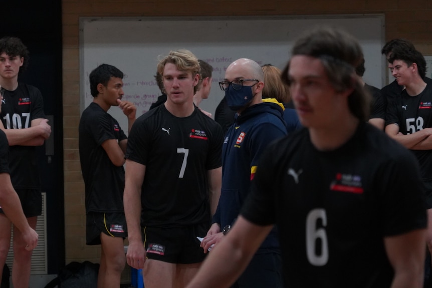 Jason Horne-Francis talks to a coach at the draft combine