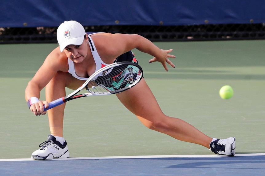 Ash Barty stretches to her right to make a forehand return on the baseline at US Open.