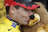 Cadel kisses mascot in yellow