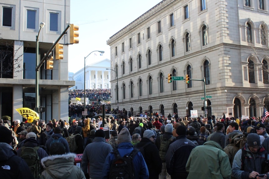 crowds of people stand in the streets of Richmond, Virginia