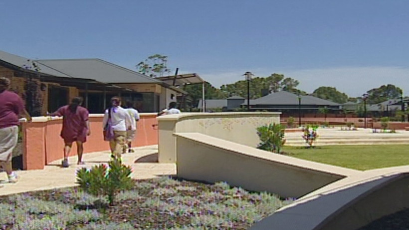 Women walk across buildings and landscaped gardens at Boronia prison in Perth