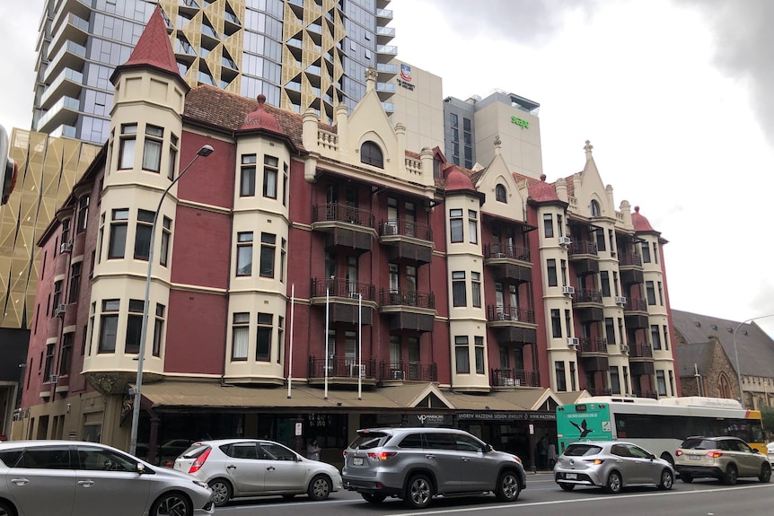 An historic apartment building on a wide street