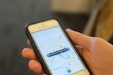 Uber user holds mobile phone