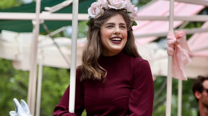 A woman sits on a carousal on Melbourne Cup Day