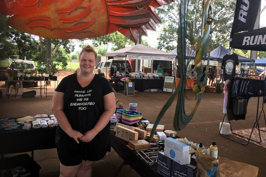 a woman in a black shirt at a market stall
