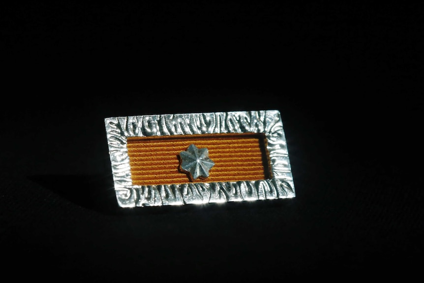A military pin on a black background