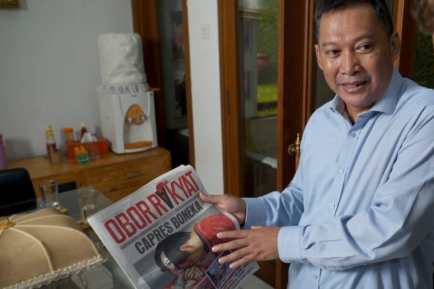 Newspaper editor Setiyardi Budiono shows the edition which landed him in jail