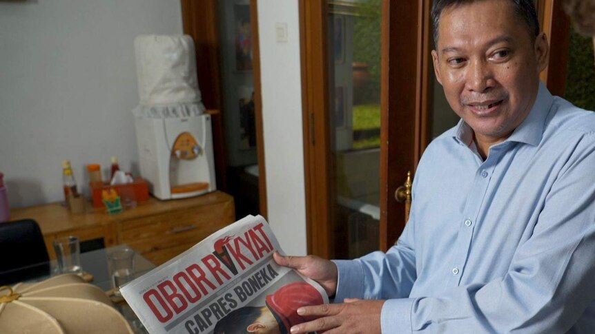 Newspaper editor Setiyardi Budiono shows the edition which landed him in jail