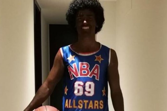 Atletico Madrid star Antoine Griezmann appears in blackface in a party costume, wearing an afro wig and basketball jersey.