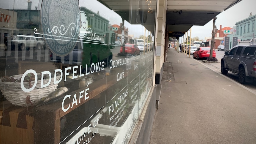 The outside of the Oddfellows Cafe on a street in Kilmore on a cloudy day.