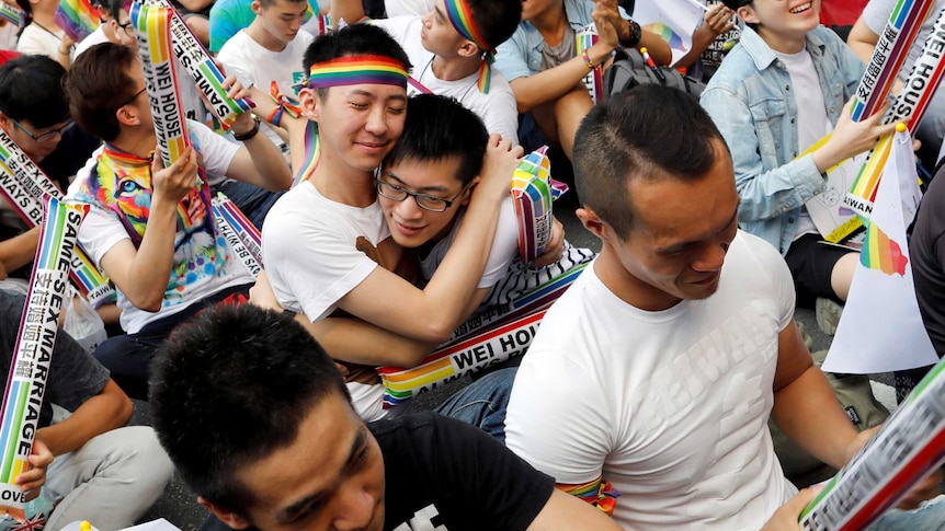 Supporters hug each other during a rally.