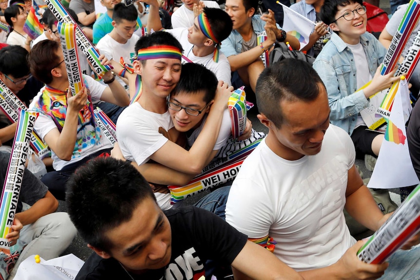 Supporters hug each other during a rally.