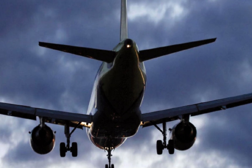 Plane taking off in silhouette with no branding.