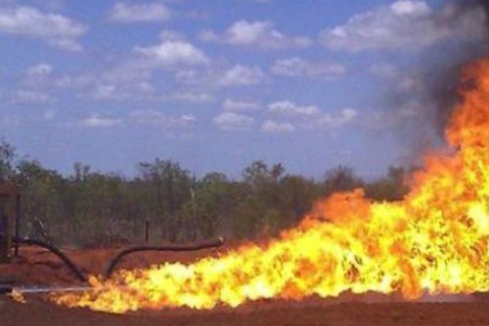 A large flame flares from a gas well.