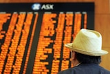 An investor watches the share prices at the Australian Securities Exchange