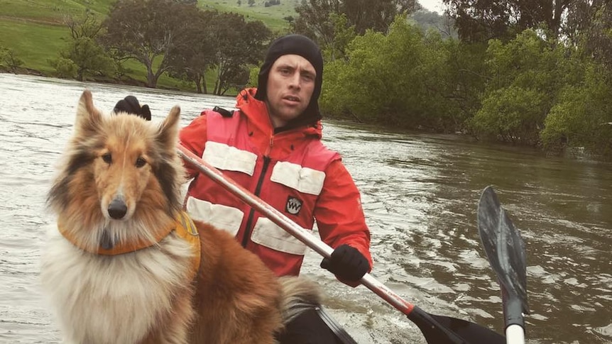 Ben Fitzpatrick and his dog Belle on the Murray River in a canoe