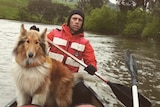 Ben Fitzpatrick and his dog Belle on the Murray River in a canoe