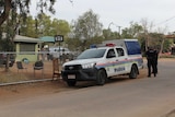 A police vehicle outside a residence in a town camp.