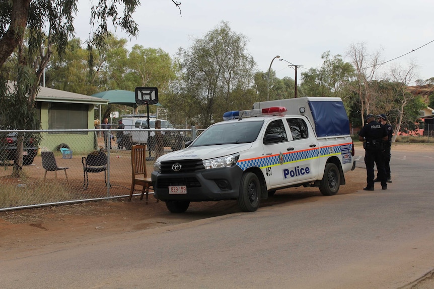 A police vehicle outside a residence in a town camp.