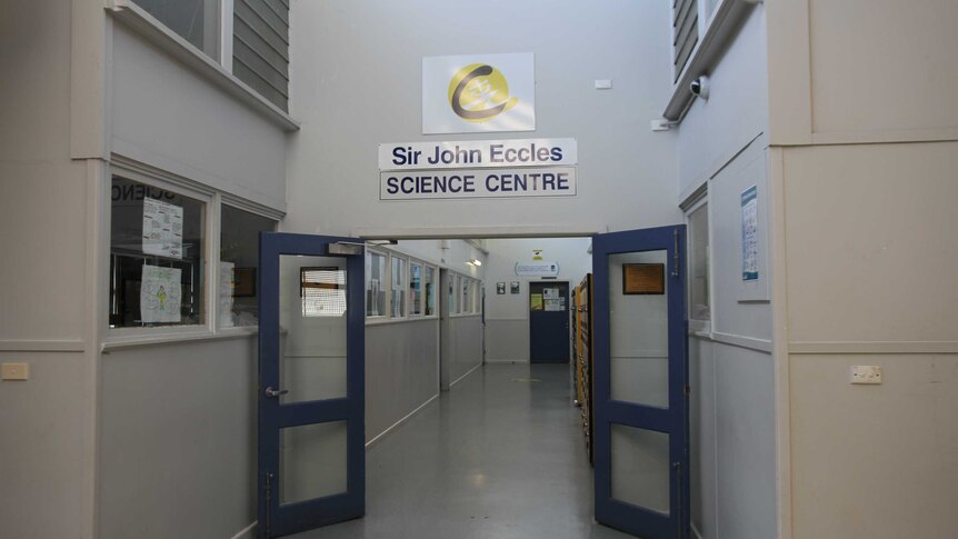 A school hallway with a sign over a door saying Sir John Eccles Science Centre