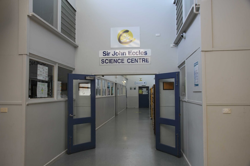 A school hallway with a sign over a door saying Sir John Eccles Science Centre