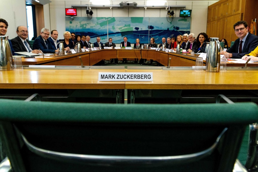 An empty chair is left out for Facebook CEO Mark Zuckerberg at a UK international grand parliamentary committee