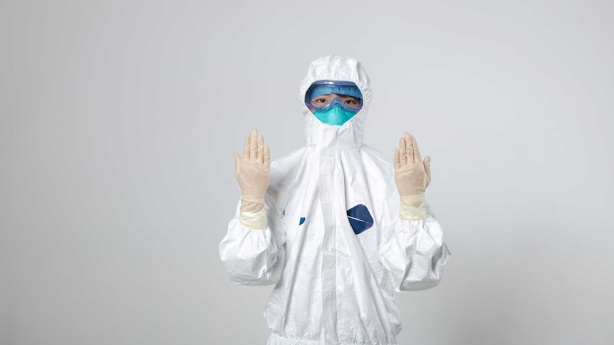 An epidemiologist standing in front of a wall.