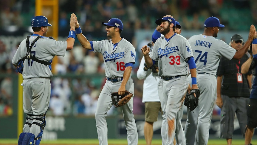 The LA Dodgers celebrate victory at the SCG
