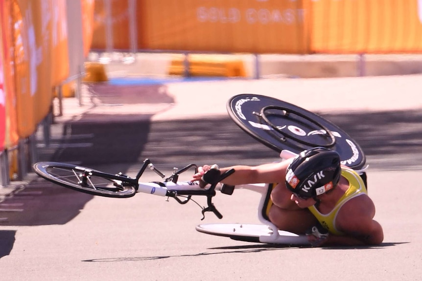 A woman in a wheelchair falls over going around a corner