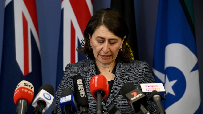 Gladys Berejiklian looks down at the ground