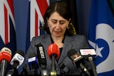 Gladys Berejiklian looks down at the ground