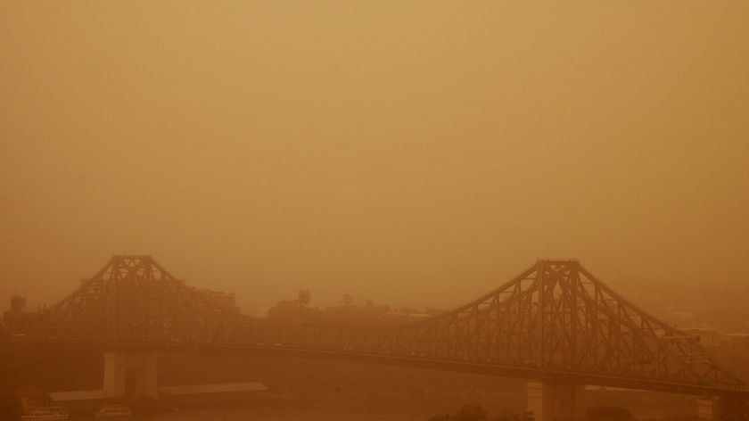 The Story Bridge in Brisbane's CBD is partly obscured by a dust storm as it rolls through the city.