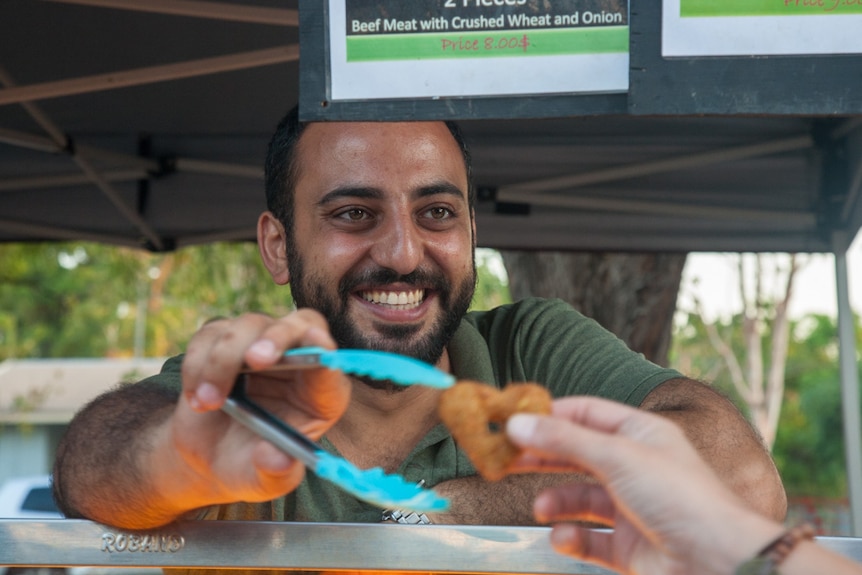 Nadeem Turkia hands out a heart-shaped falafel to a customer