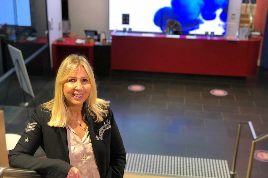 Scape CEO Anouk Darling stands on a staircase and looks at the camera.