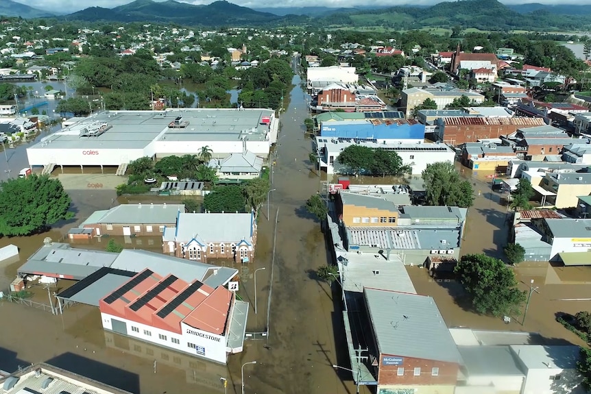 An aerial view of a country town flooded by flood waters.