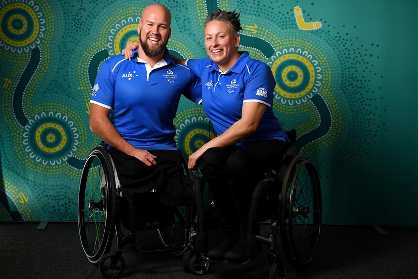 Paralympic athletes with arms around one another smiling for a photo
