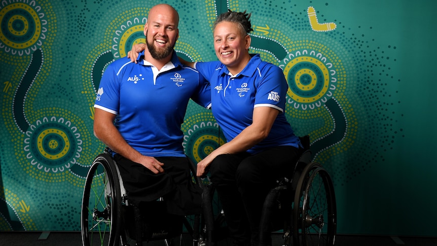 Paralympic athletes with arms around one another smiling for a photo