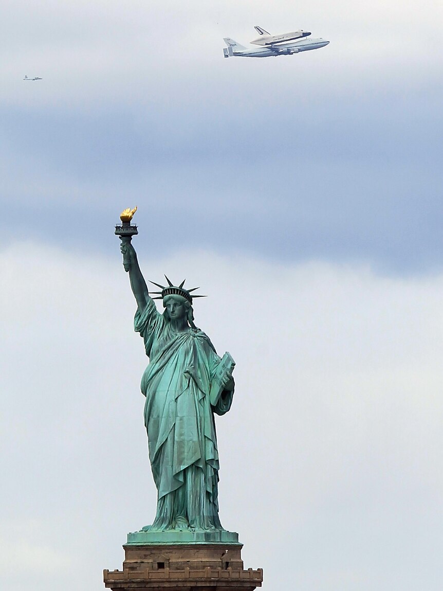 Enterprise flies past the Statue of Liberty