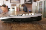 a landline phone handset lying a pub bar