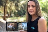 A woman seated on a bench holding two photos of her grandparents