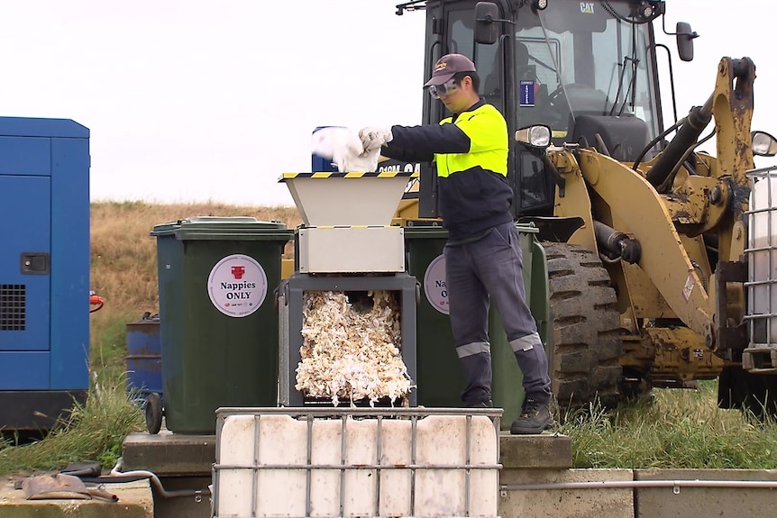 A man recycles nappies at a waste management site.