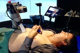 Ultrasound robot working on male patient