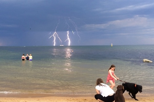 Two bolts of lightning strike the water off Elwood beach simultaneously
